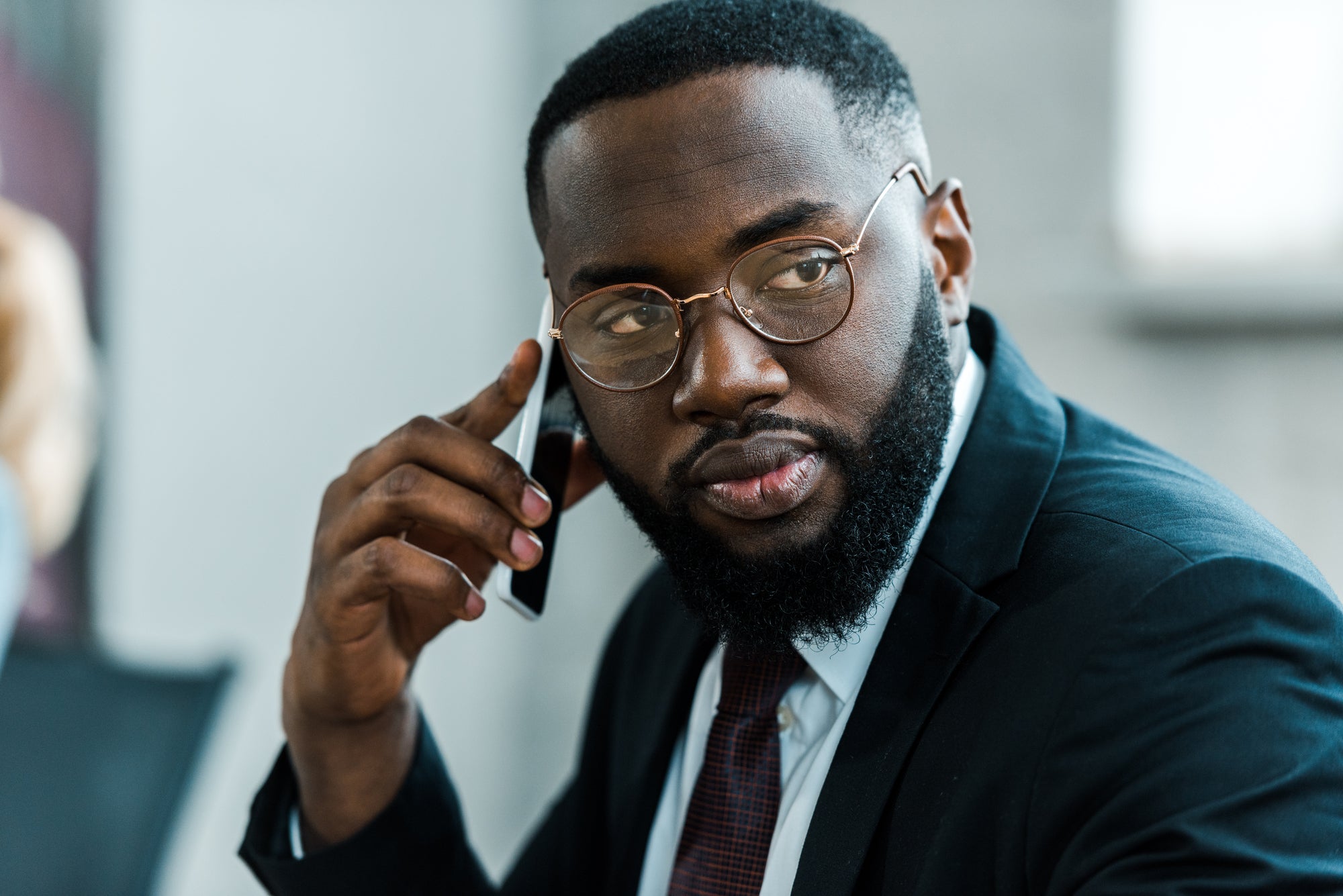 black businessman with beard on phone